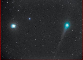A bright comet and stars in a dark night sky
